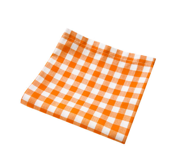 istock Orange folded picnic cloth isolated on white.Food decor. Kitchen towel. 1446911100