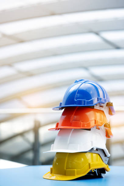 Helmets for construction workers, engineers, technicians, inspectors who work on construction sites. Safety hardhat while working to prevent accidents. work equipment of Blue collar stock photo