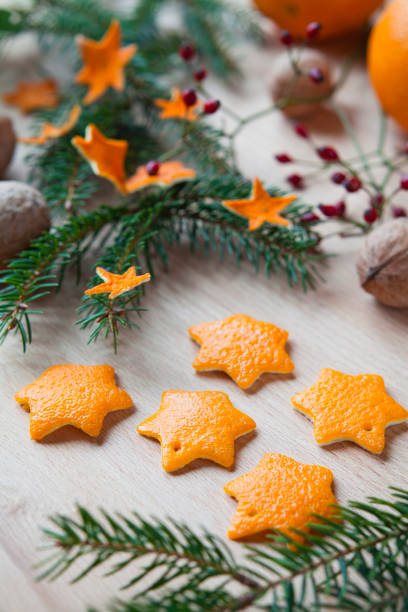 Great idea of festive activity for kids, zero waste handmade Christmas decorations  -  made by cutting star shapes from the scrap orange or other citrus peel. Once they dry can be used as ornaments to decorate any Christmas tree.