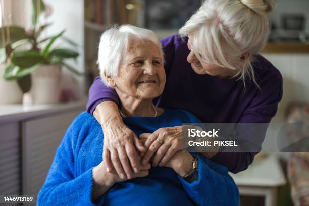 Woman Hugging Her Elderly Mother Stock Photo - Download Image Now - Senior Adult, Dementia, Healthcare Worker