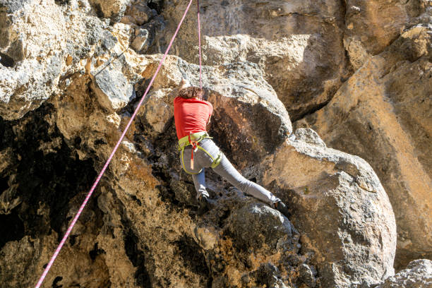 climber is  climbing on the vertical rock in Antalya stock photo