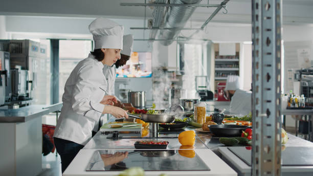 istock Professional chef frying organic vegetables on kitchen stove 1446914172