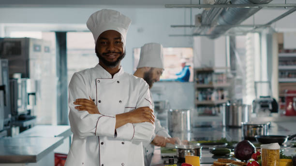 istock Portrait of confident man working as chef in gourmet kitchen 1446914297