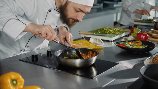 istock Professional cook preparing culinary recipe with vegetables 1446914465