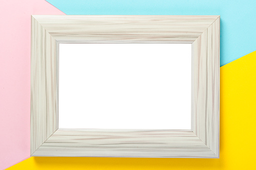 Blank wooden white photo frame on colourful background, save clipping path.