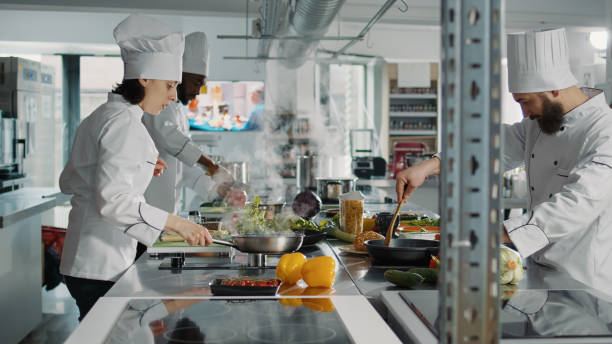 istock Diverse team of chefs preparing gourmet dish ingredients 1446915928