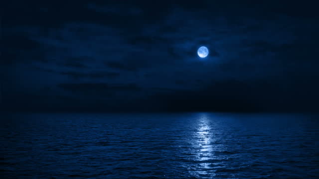 Traveling Over The Sea At Night With Moon Reflecting
