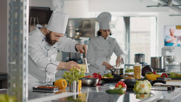 istock Authentic cook grating parmesan cheese on gourmet dish 1446919050