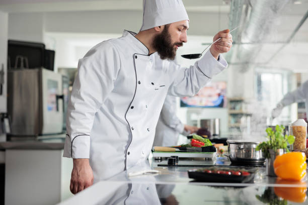 istock Master chef tasting gourmet dish while cooking food for dinner service at fine dining restaurant. 1446919564