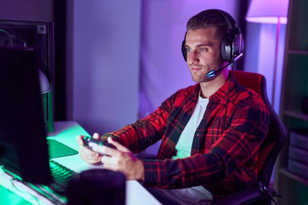 istock Young caucasian man streamer playing video game using joystick at gaming room 1446920540
