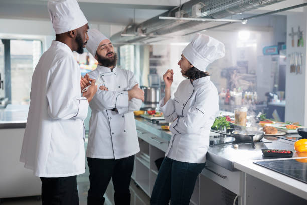 istock Professional food industry workers brainstorming lunch meal ideas while standing in kitchen. 1446921227