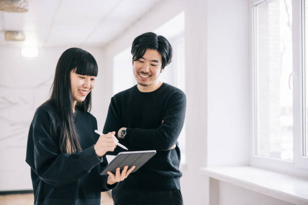 Japanese creative designers at office hallway