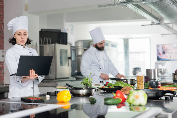istock Professional food industry worker with computer searching for gastronomic meal. 1446922548