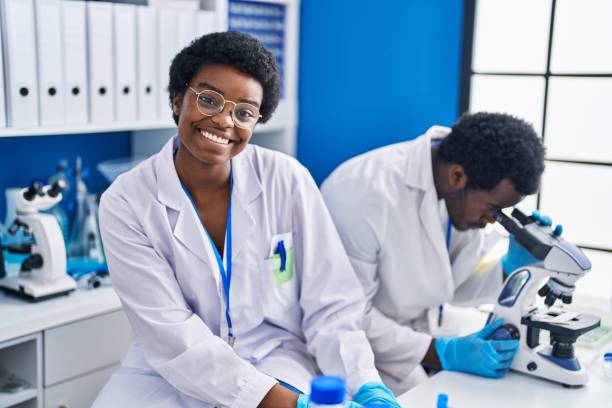 istock African american man and woman scientists using microscope at laboratory 1446925366