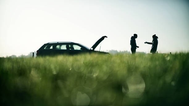 A family with a car breakdown. Silhouettes of people attempting repairs and arguing with each other