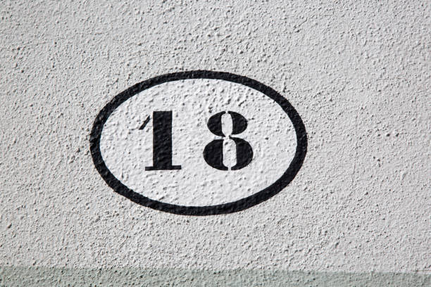 istock Black and White Number Eighteen on Stone Wall 1446926305