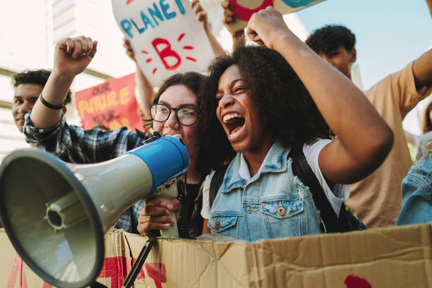 istock Youth climate activists protesting with a megaphone 1446928324