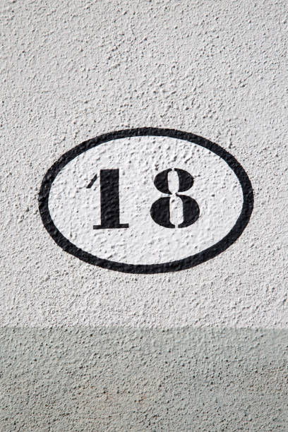 istock Black and White Number Eighteen on Stone Wall 1446928377