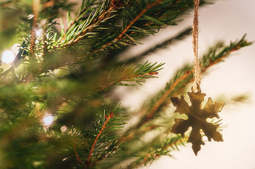 Close-up background of christmas tree with decorations and fairy lights