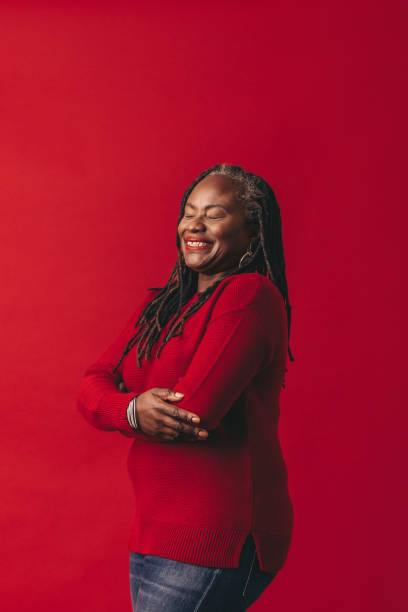 istock Carefree woman with dreadlocks smiling happily in a studio 1446929423