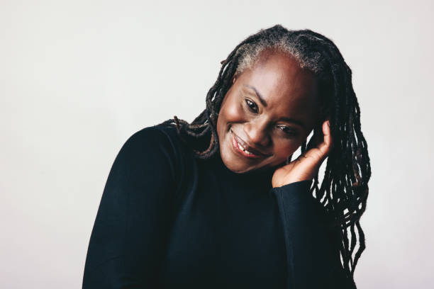 istock Confident mature woman with dreadlocks smiling at the camera 1446929484