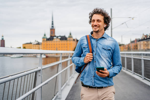 istock Young Man Using Phone On The Bridge In Stockholm 1446931255