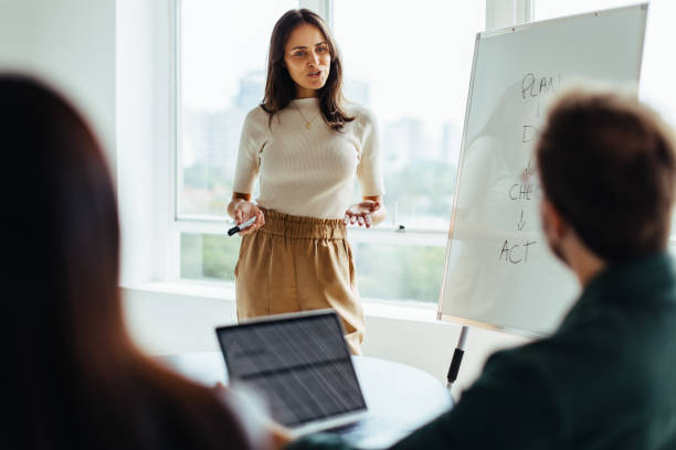 istock Female professional giving a presentation in an office 1446934056