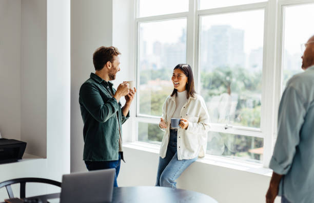 istock Happy business people having a coffee break in an office 1446934271