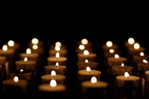 istock Many burning candles on a black background. burning candles place for text cope space 1446935415