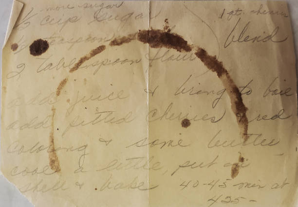 istock Stained and discolored handwritten recipe for cherry pie. 1446936869