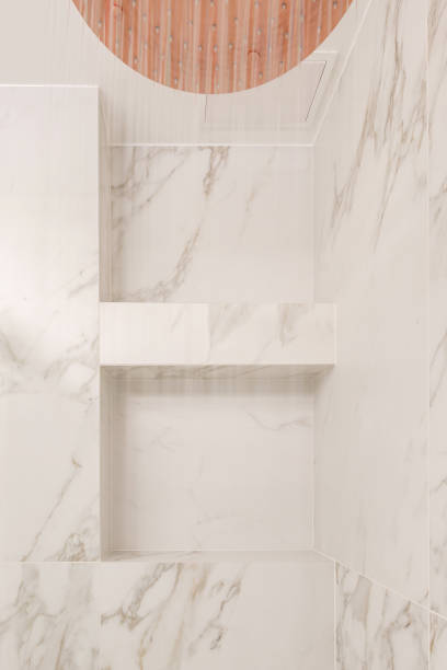 istock Modern minimalistic bathroom interior design with marble tiles, copper shower with running water. Aesthetic simple interior design concept. 1446937157