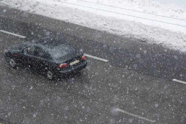 istock Car on the road in the snowstorm 1446937401