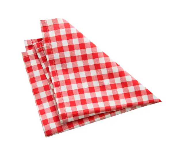 Photo of Checkered red kitchen towel.Picnic dish cloth,.folded napkin. Tablecloth isolated.