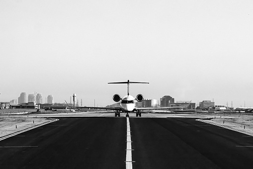 Black and White Photo of a LearJet on the Tarmac at an Airport