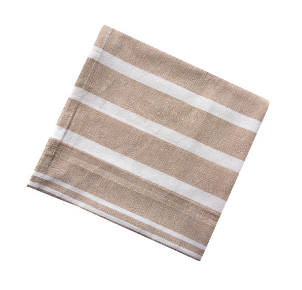 istock Kitchen towel isolated on white. Brown beige folded cloth.Food serving design element. 1446941133