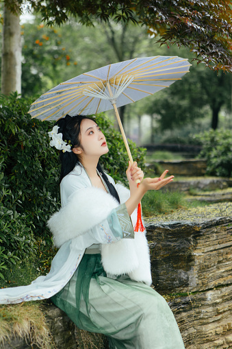 Asian Hanfu Beauty Feels Nature in Outdoor Rainy Weather