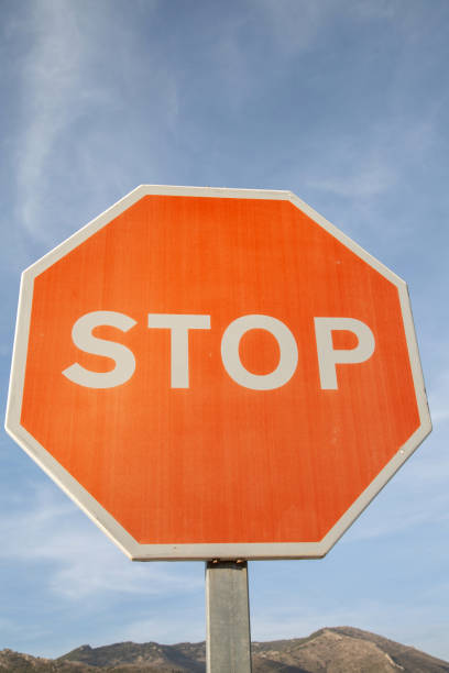 istock Red Stop Sign against Blue Sky 1446942620
