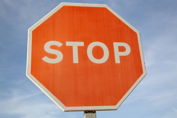 istock Red Stop Sign against Blue Sky 1446942846