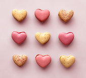 istock Valentines Day Pink and Cream Heart Shaped French Macaroon Cookies Abstract Background Love Concept 1446943223