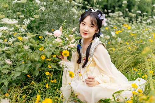An Asian Hanfu Beauty in the Flowers