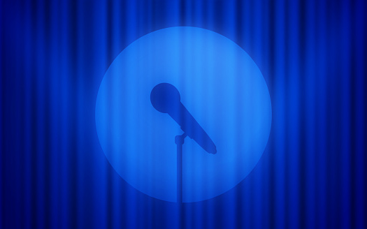 Spotlight stand up comedy performance show blue curtain stage background.