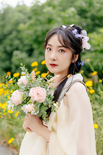 An Asian Hanfu Beauty in the Flowers