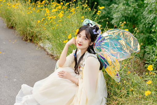 An Asian beauty in a Chinese costume,  , was in the outdoor flowers