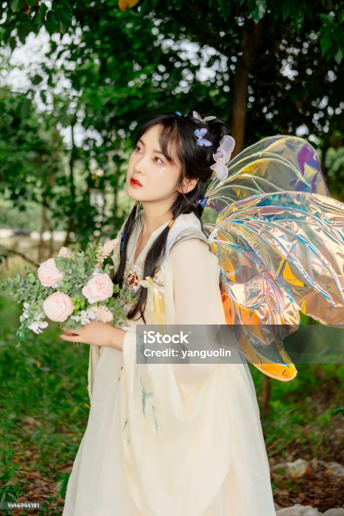 An Asian beauty in a Chinese costume,  , was in the outdoor flowers 20-24 Years Stock Photo