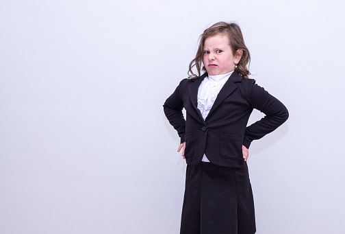 A child in a school uniform with an emotional facial expression.