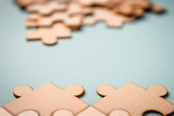 Wooden puzzles jigsaw solving problems in business. stock photo