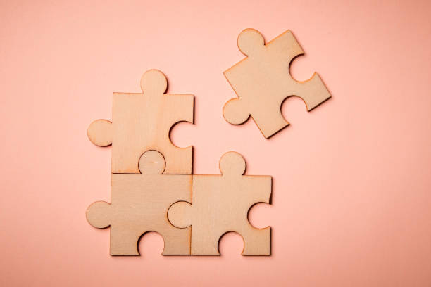 Wooden puzzles jigsaw solving problems in business. stock photo