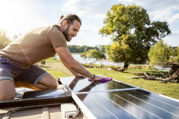 istock Man cleaning the solar panel on the roof of a camper van 1446944821