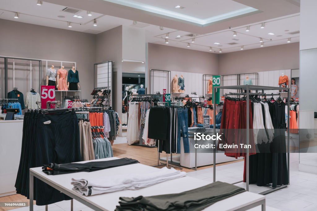 Female Clothing store retail display in shopping mall with discount sales tag Department Store Stock Photo