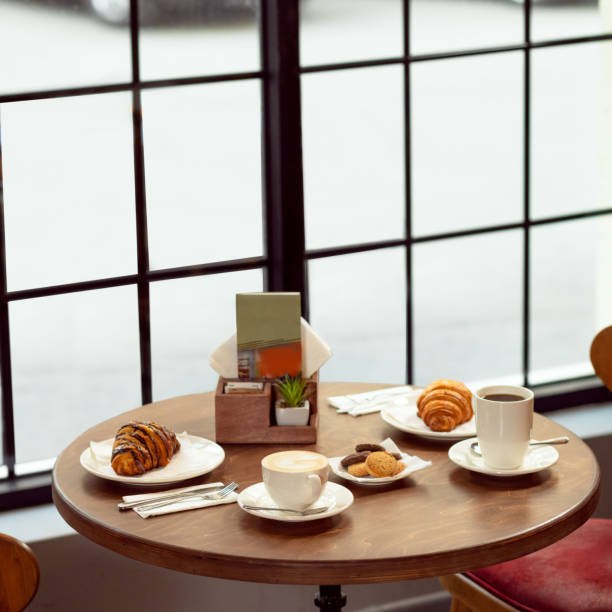 Coffee and croissant on white table. French breakfast.